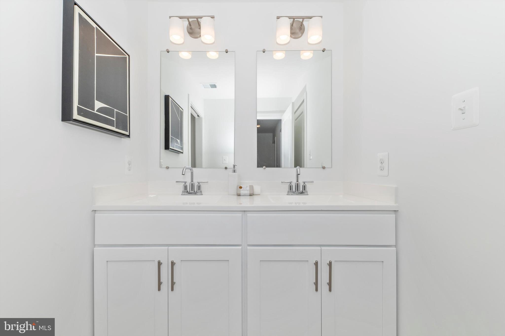 720 Iron Frg Road Frederick, MD 21702 - Photo 29 of 33 a bathroom with a sink vanity and a mirror