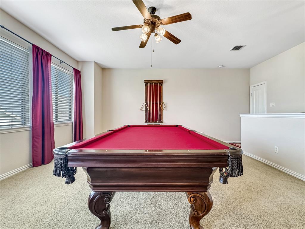 401 Varnum Way Fairview, TX 75069 - Photo 26 of 33 a bed room with a bed and a chandelier