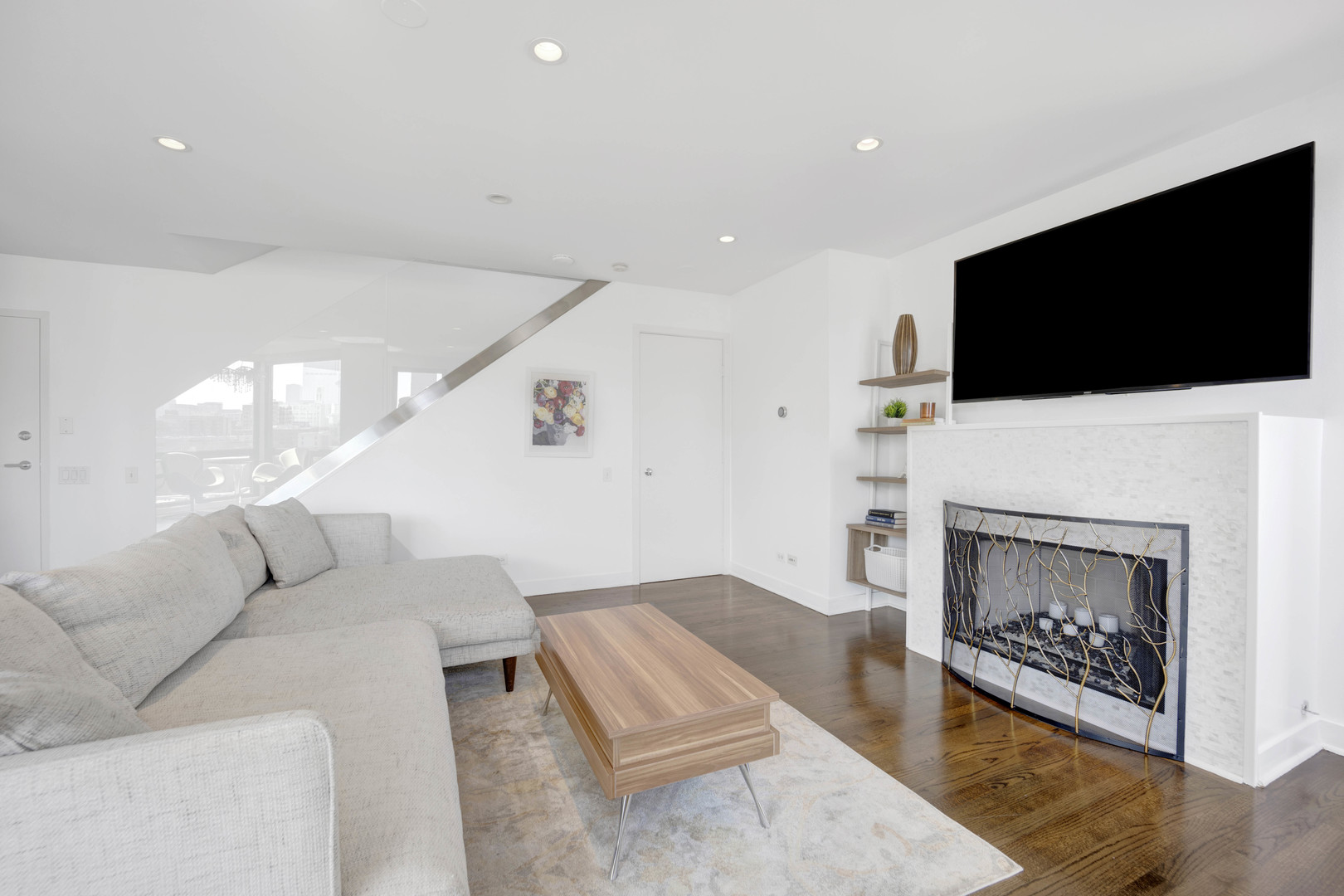 222 South Racine Avenue, Unit 606 Chicago, IL 60607 - Photo 5 of 20 a living room with furniture a flat screen tv and a fireplace