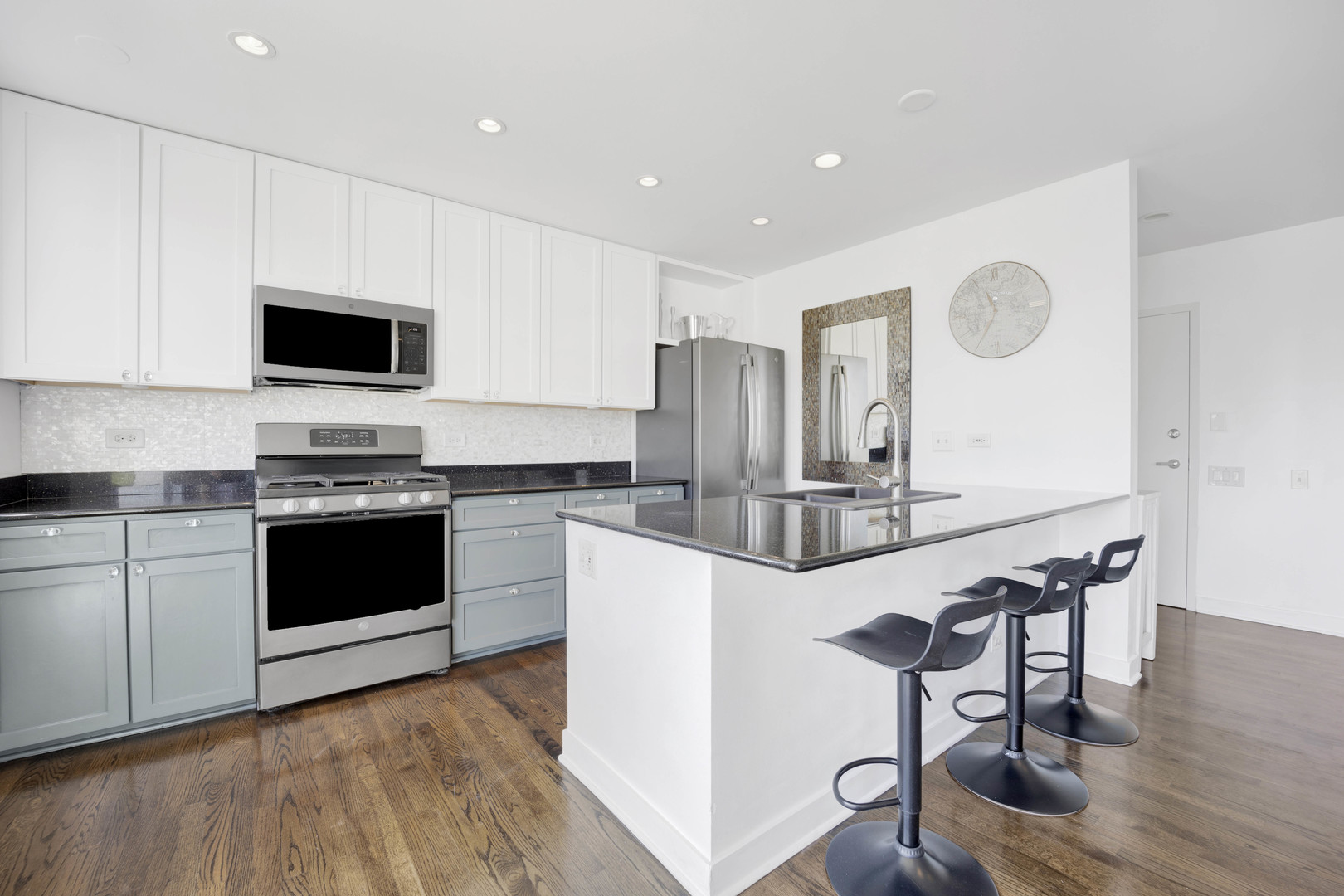 222 South Racine Avenue, Unit 606 Chicago, IL 60607 - Photo 8 of 20 a kitchen with stainless steel appliances kitchen island granite countertop a stove a sink and a refrigerator