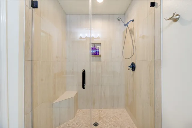 a bathroom with a shower and a shower