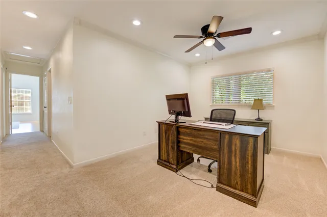 a view of workspace with wooden floor and windows