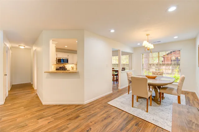 a view of a dining room with furniture and wooden floor
