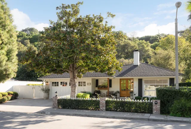 a front view of a house with a garden