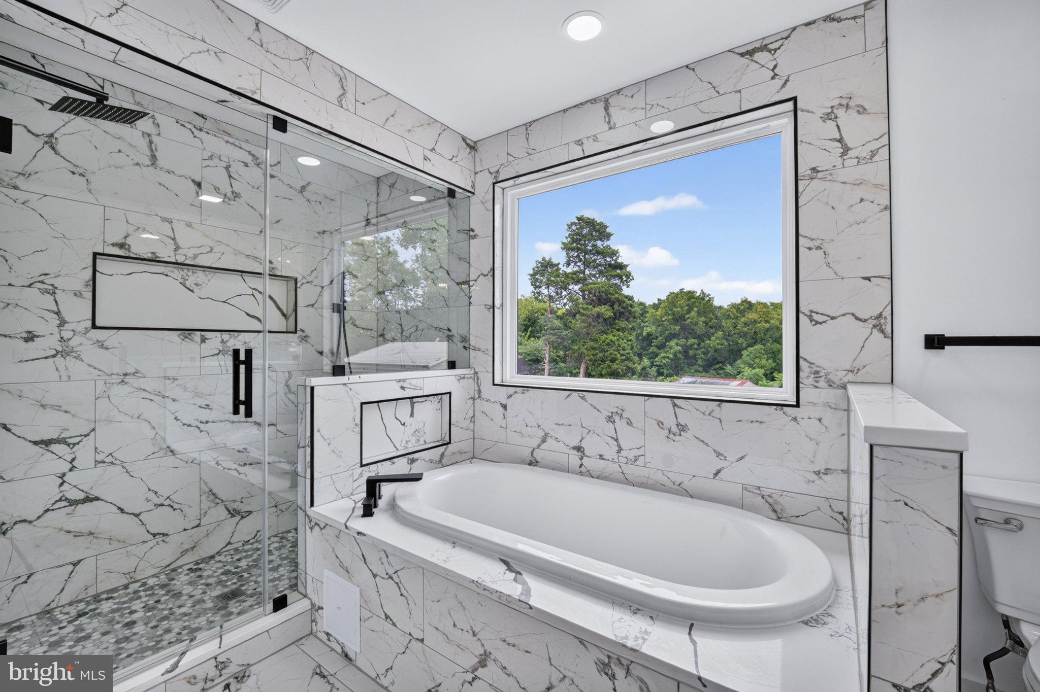 8323 Rolling Road Manassas, VA 20110 - Photo 53 of 97 Luxurious marble bath with serene views.