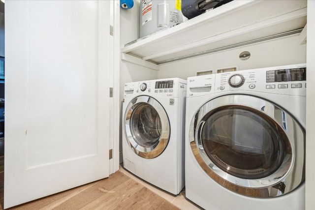 a bathroom with a sink a toilet a mirror and shower