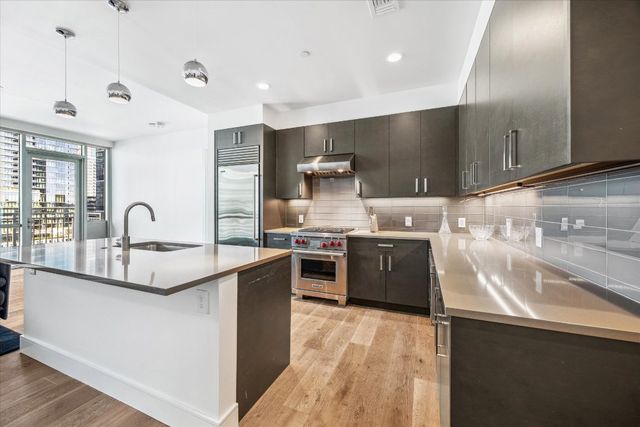 a living room with stainless steel appliances granite countertop furniture and a kitchen counter top