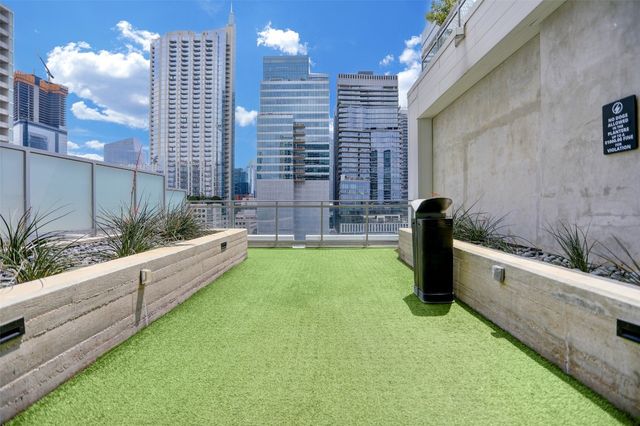a large kitchen with kitchen island a counter top space a sink a stove and cabinets