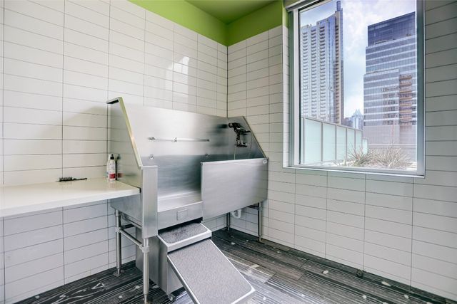 a view of a dining room with furniture a kitchen and chandelier