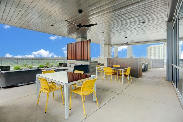 a view of a patio with couches table and chairs and potted plants