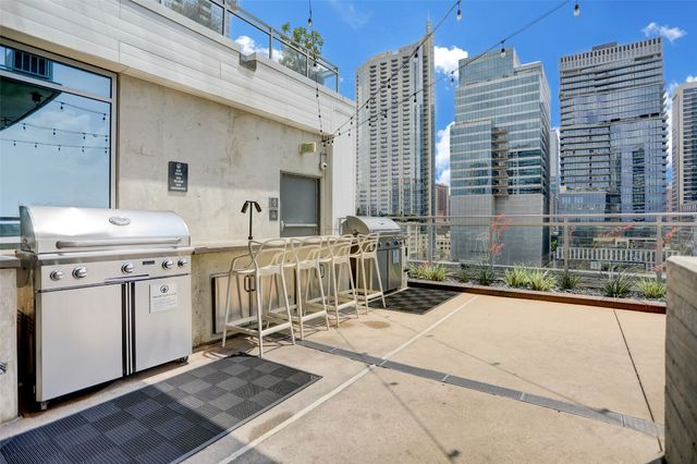 a living room with patio furniture and a flat screen tv
