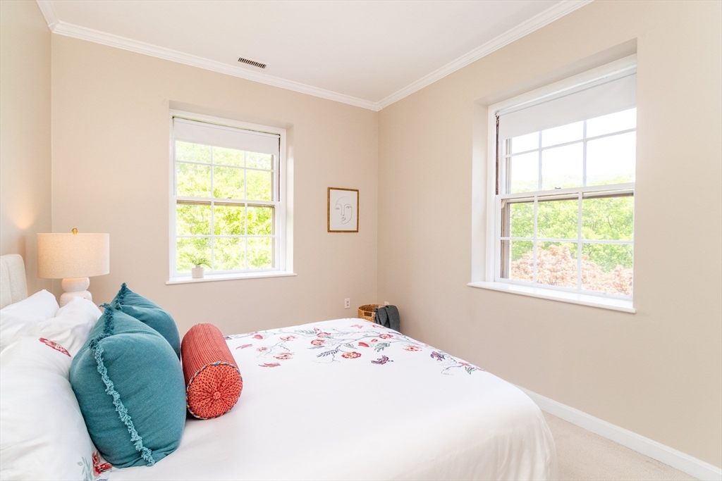 60e Glen Road, Unit 306 Brookline, MA 02445 - Photo 18 of 27 a bedroom with a bed and a window