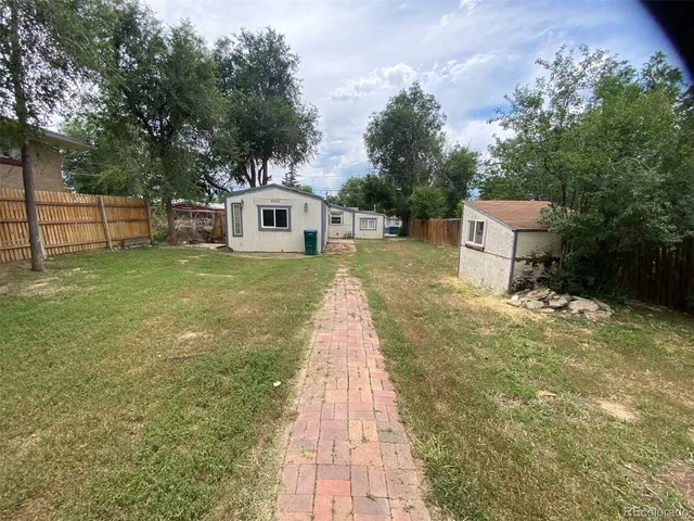 a pathway of a house with a yard