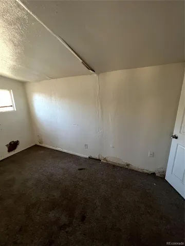 an empty room with a empty space and window