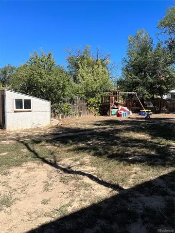 a view of a wooden house with a yard