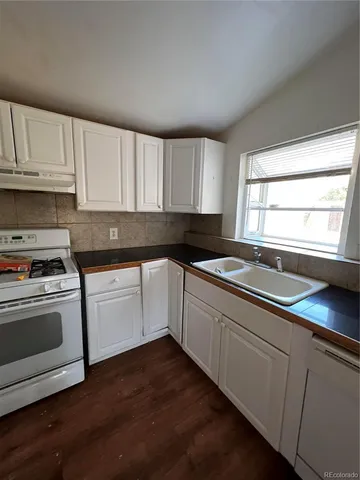 a kitchen with a stove a sink and a microwave