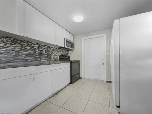 a kitchen with stainless steel appliances granite countertop a sink and cabinets