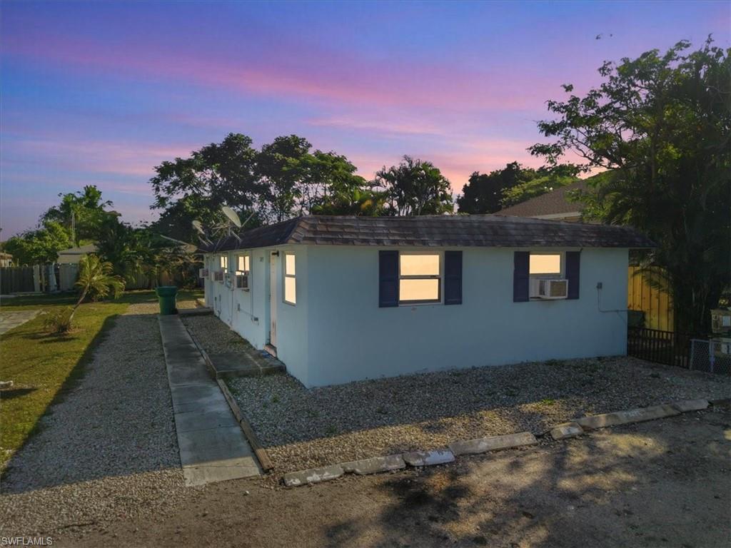 2495 Bayside Street Naples, FL 34112 - Photo 2 of 36 a view of a house with a yard