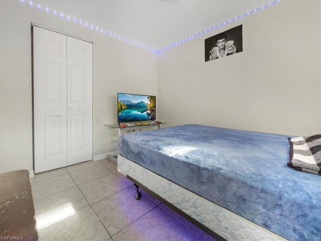 2495 Bayside Street Naples, FL 34112 - Photo 23 of 36 a living room with hard wood floors and a couch