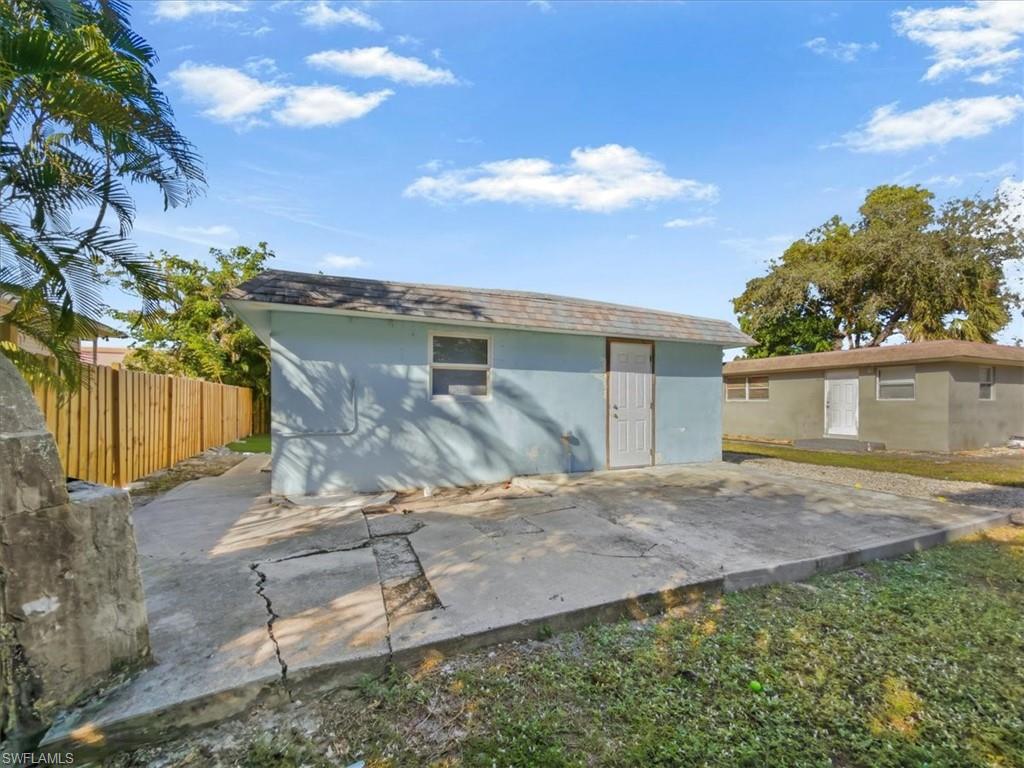 2495 Bayside Street Naples, FL 34112 - Photo 26 of 36 a view of a house with backyard and a tree