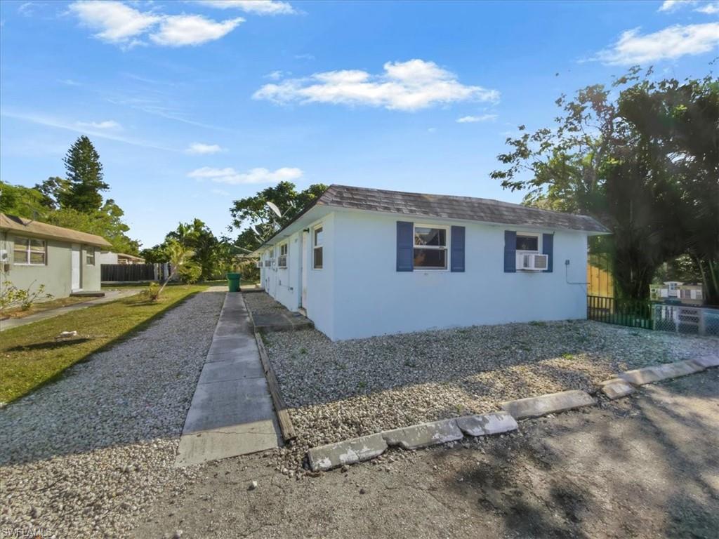 2495 Bayside Street Naples, FL 34112 - Photo 30 of 36 a view of a house with a yard