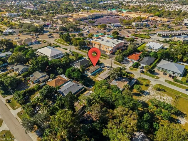 an aerial view of multiple houses with yard