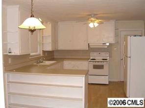 a kitchen with a refrigerator and a sink