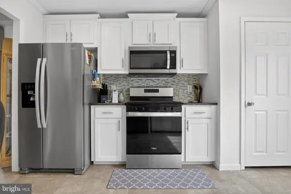 a kitchen with stainless steel appliances a refrigerator stove and microwave
