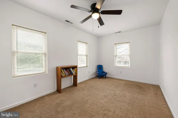 an empty room with windows and closet