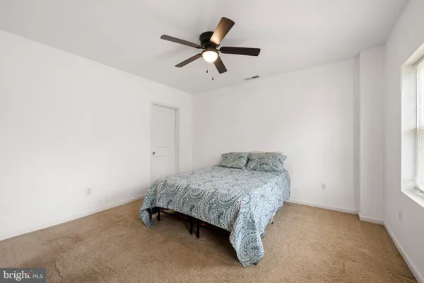 a bedroom with a bed and window