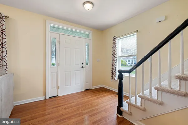 a view of entryway with wooden floor and stairs