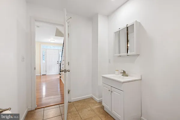 a bathroom with white cabinets