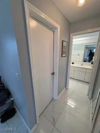 a view of a hallway and a livingroom with furniture