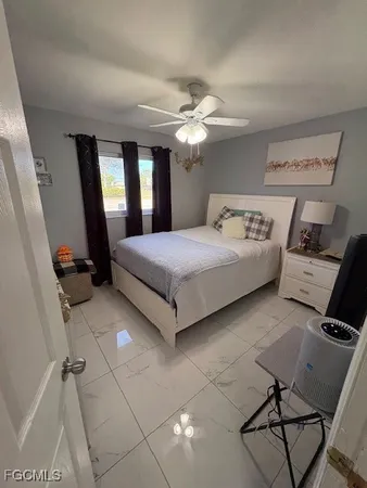 a bedroom with a bed and window