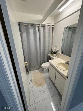 view of bathroom with a sink and mirror