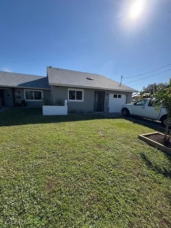 a view of a house with a yard
