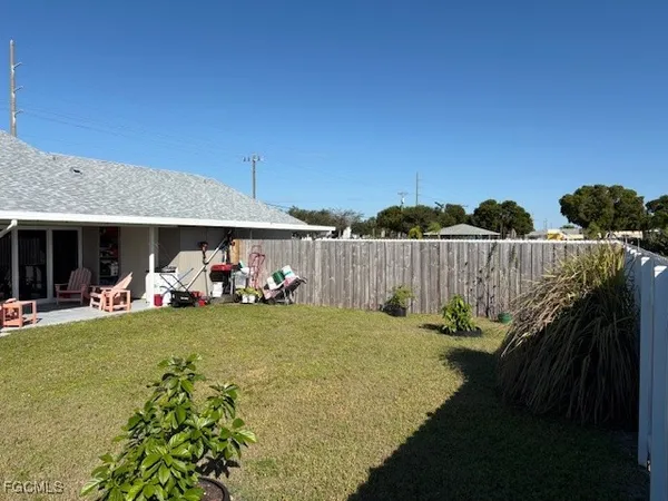 a view of a house with backyard and sitting area