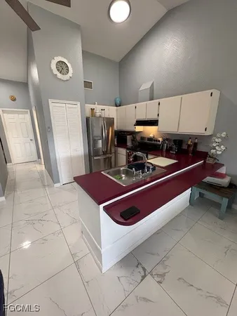 a kitchen with stainless steel appliances granite countertop a sink and a stove