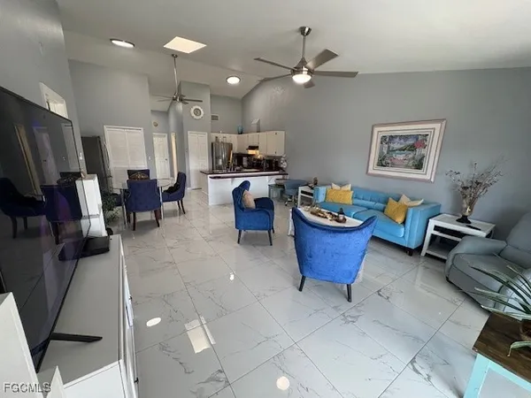 a living room with furniture a window and a flat screen tv