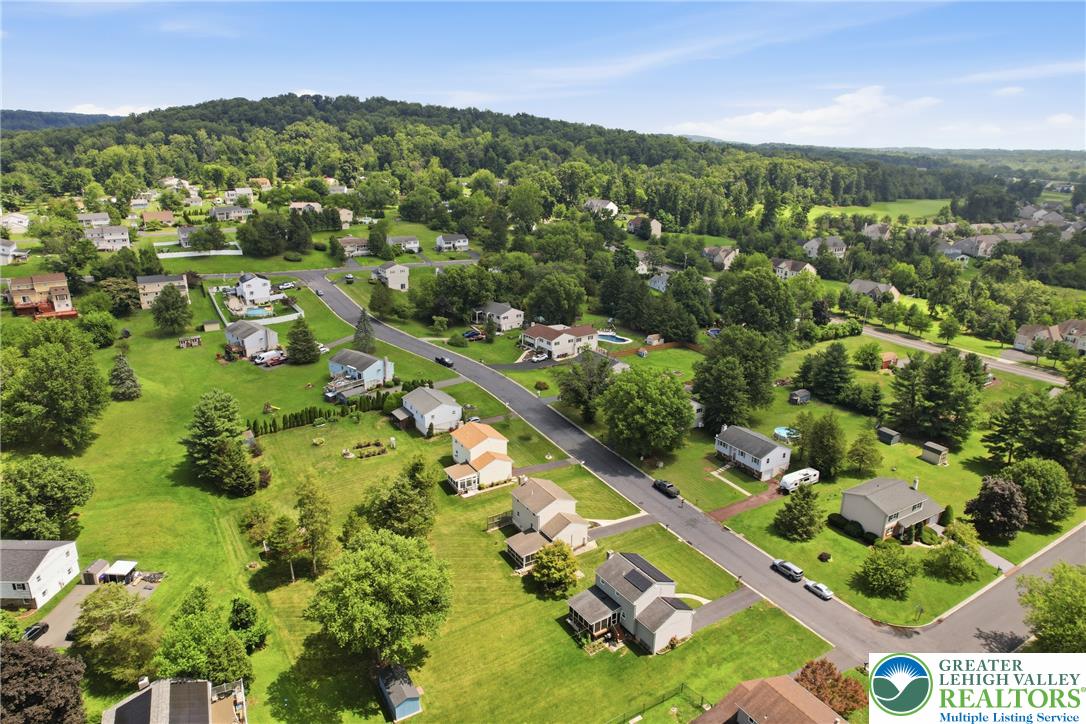 1385 Woodmere Road Pottstown, PA 19464 - Photo 54 of 57 An aerial perspective reveals a serene residential neighborhood nestled among verdant hills and mature trees.