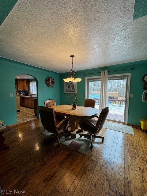 3096 Wayland Road Diamond, OH 44412 - Photo 6 of 26 Dining area with a chandelier, a textured ceiling, and hardwood / wood-style floors