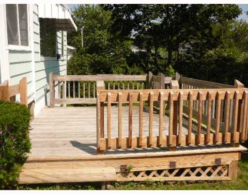5 Andrew Comstock Road Warwick, RI 02886 - Photo 6 of 12 Patio/Deck. Sunny side-deck borders stairway down to lower level and private path to water.