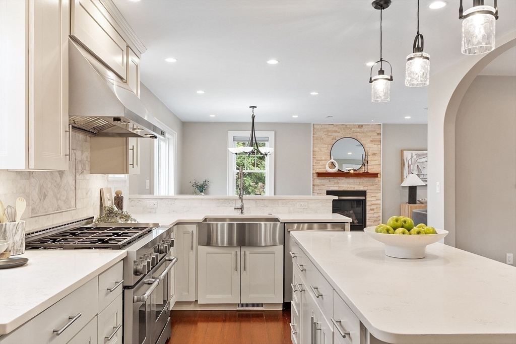 1 Pine Grove Road Medfield, MA 02052 - Photo 14 of 36 a kitchen with kitchen island granite countertop a stove a sink a dining table and chairs