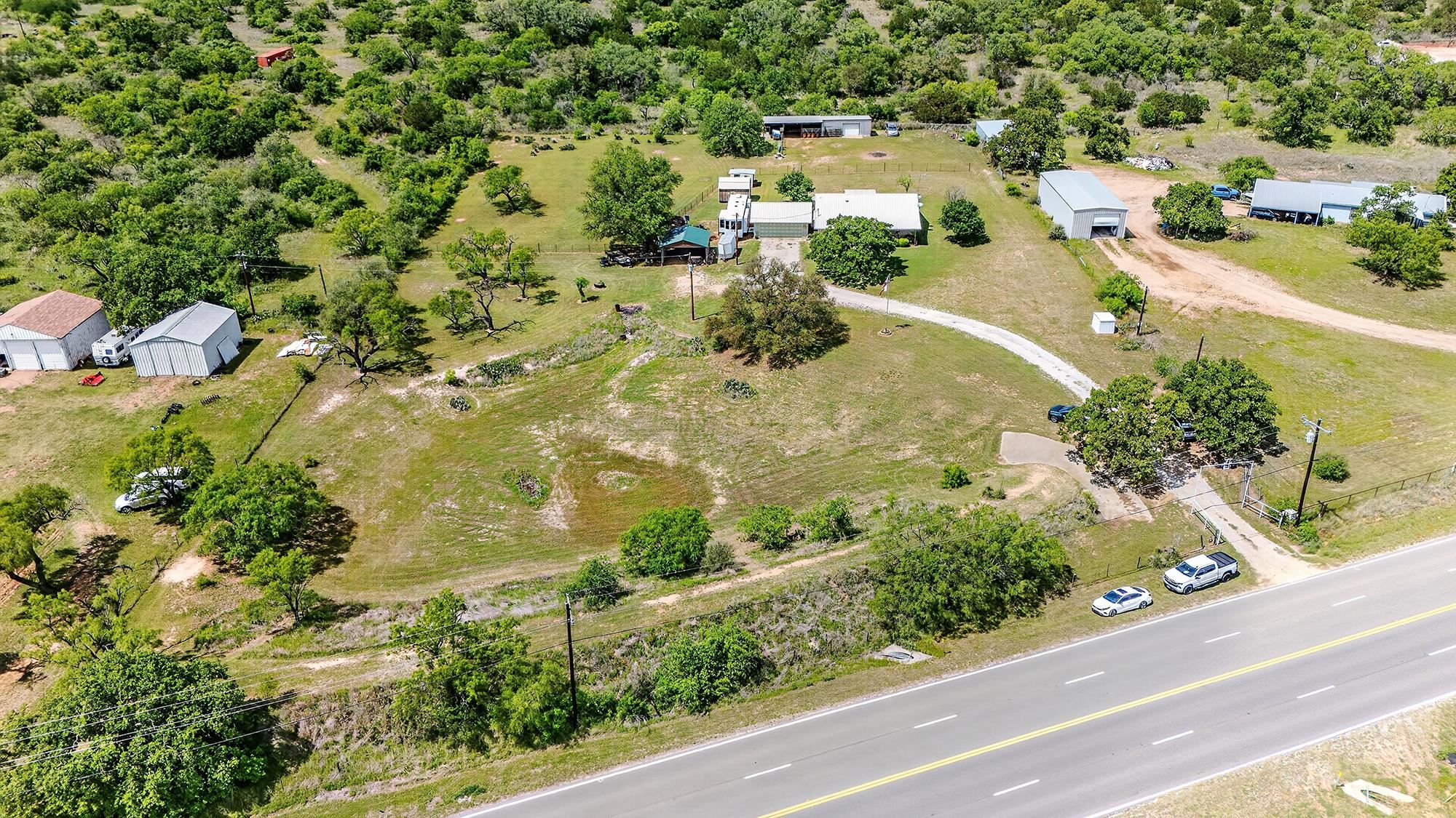 10465 Ranch To Market 1431 Buchanan Dam, TX 78609 - Photo 7 of 29 an aerial view of residential houses with outdoor space and trees