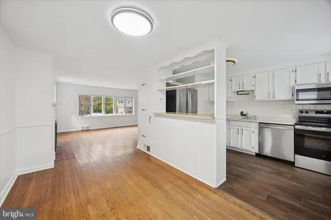 a kitchen with a refrigerator and a stove top oven