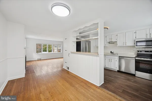 a kitchen with a refrigerator and a stove top oven