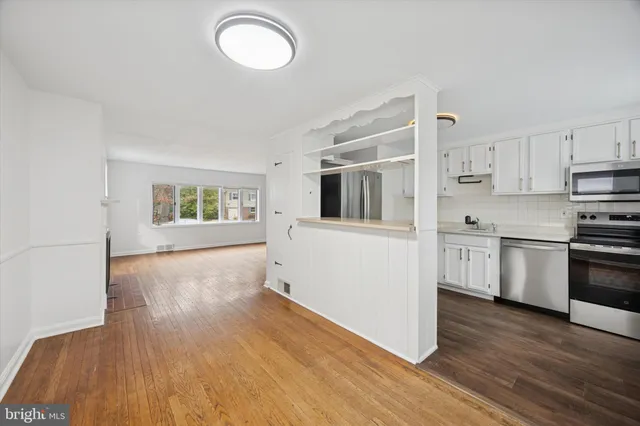a kitchen with a refrigerator and a stove top oven