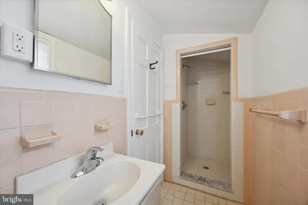 a bathroom with a sink and shower
