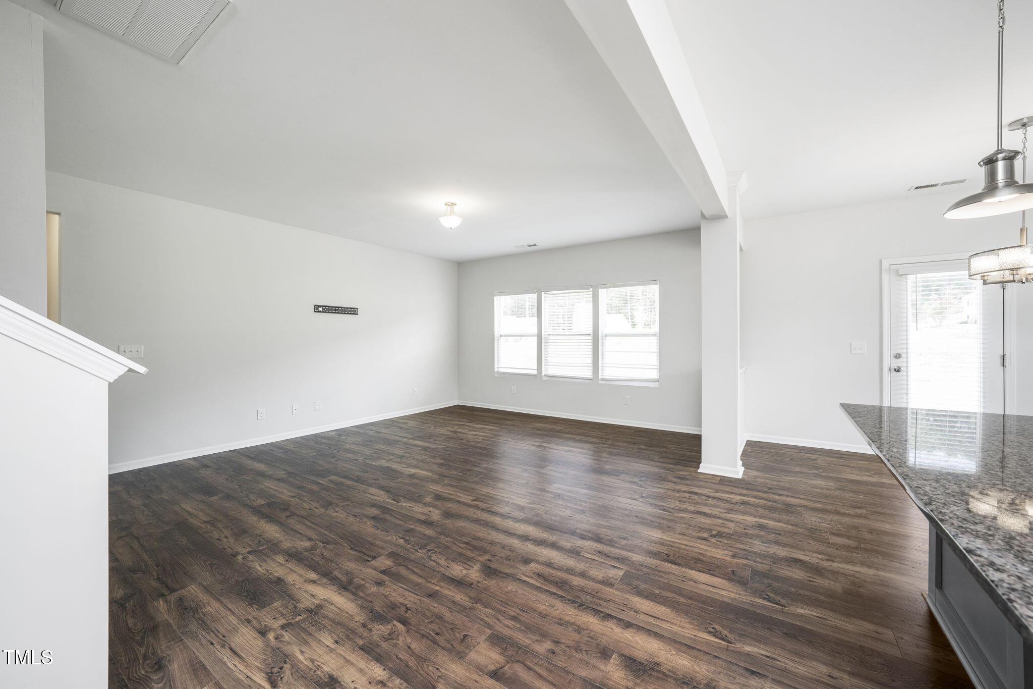 5502 Ripplebrook Drive Durham, NC 27712 - Photo 11 of 50 an empty room with wooden floor and windows