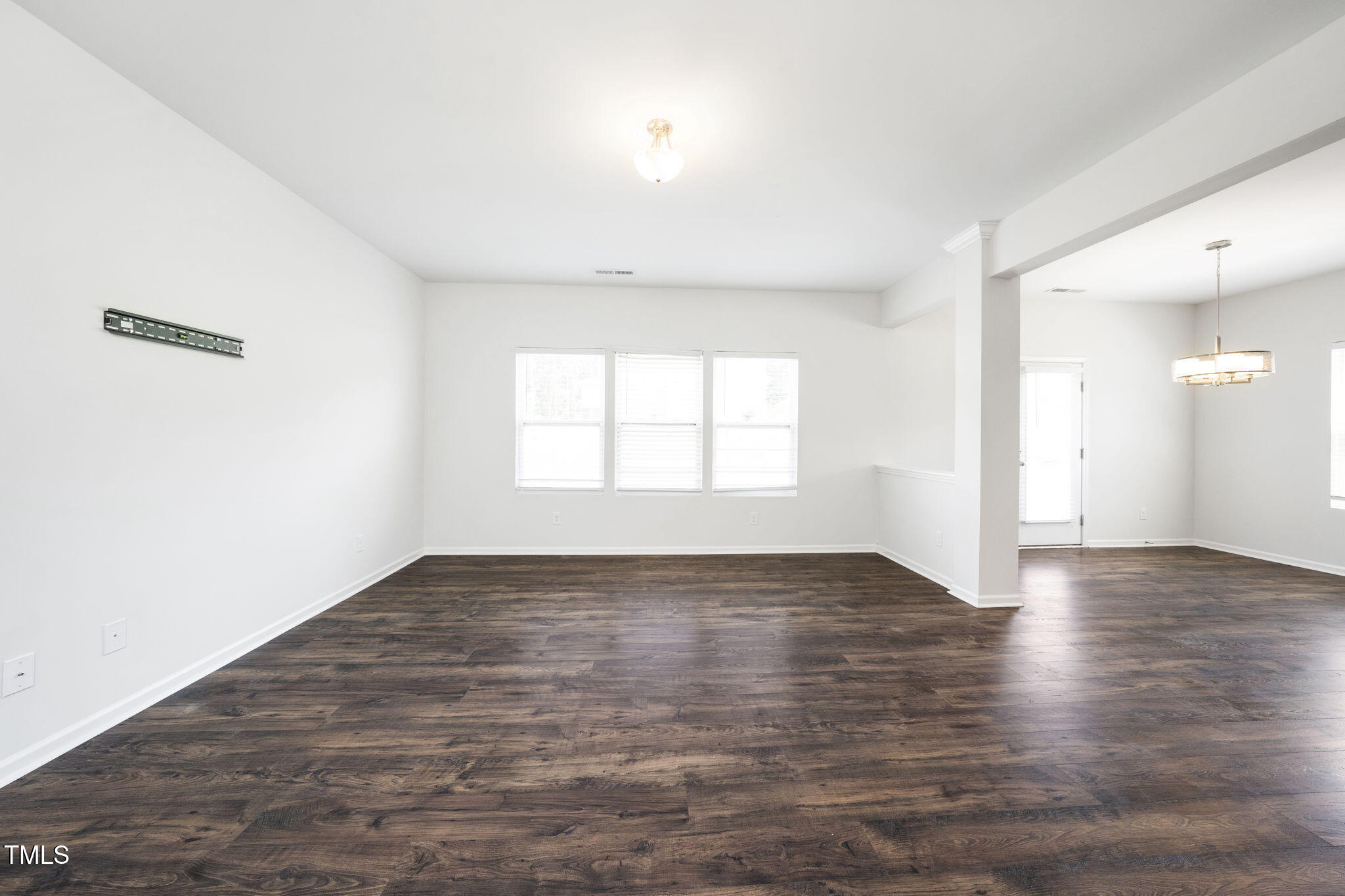 5502 Ripplebrook Drive Durham, NC 27712 - Photo 12 of 50 an empty room with wooden floor and windows